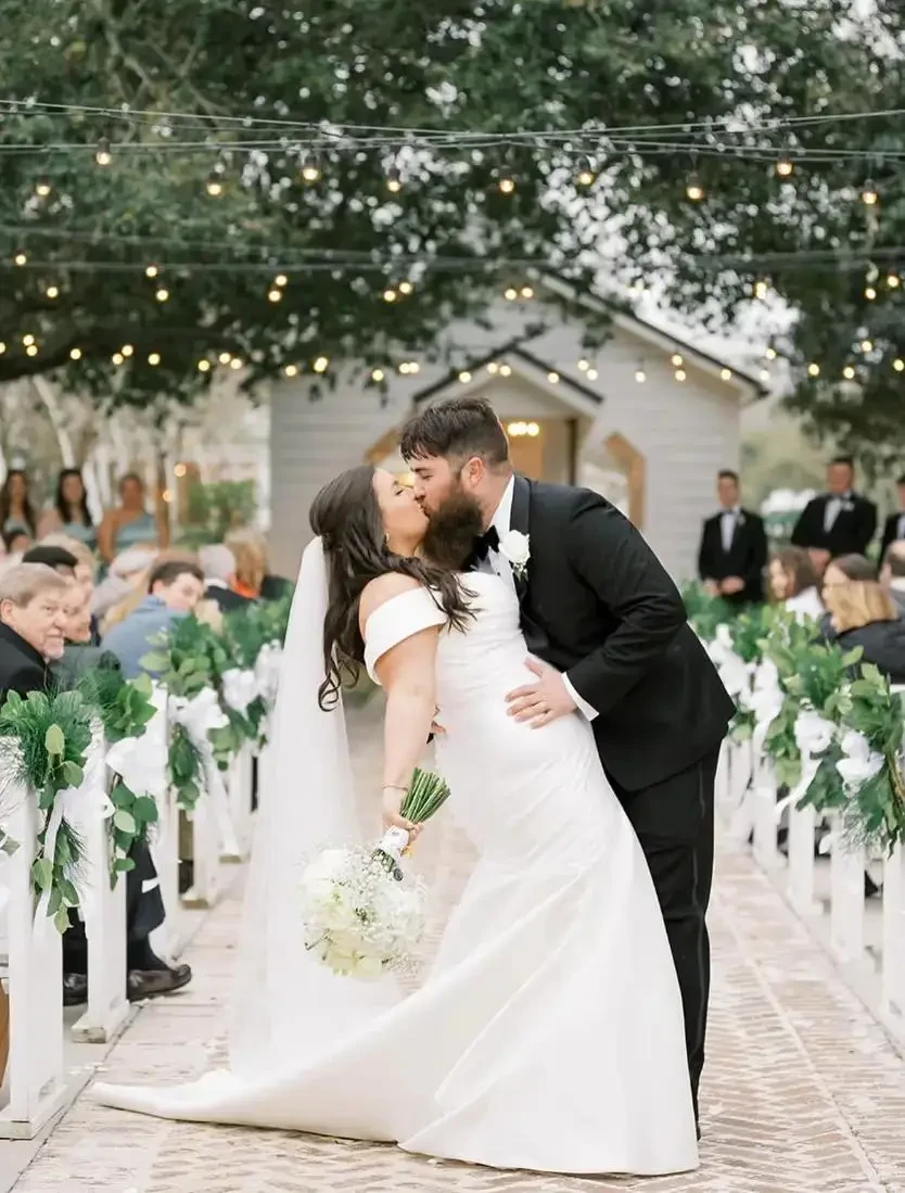 Model wearing a white bridal dress with flowers
