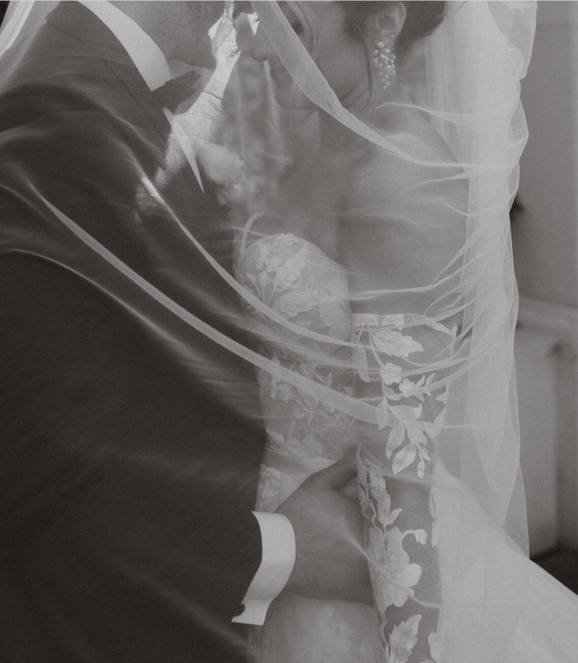 Сouple wearing a white gown and a black suit