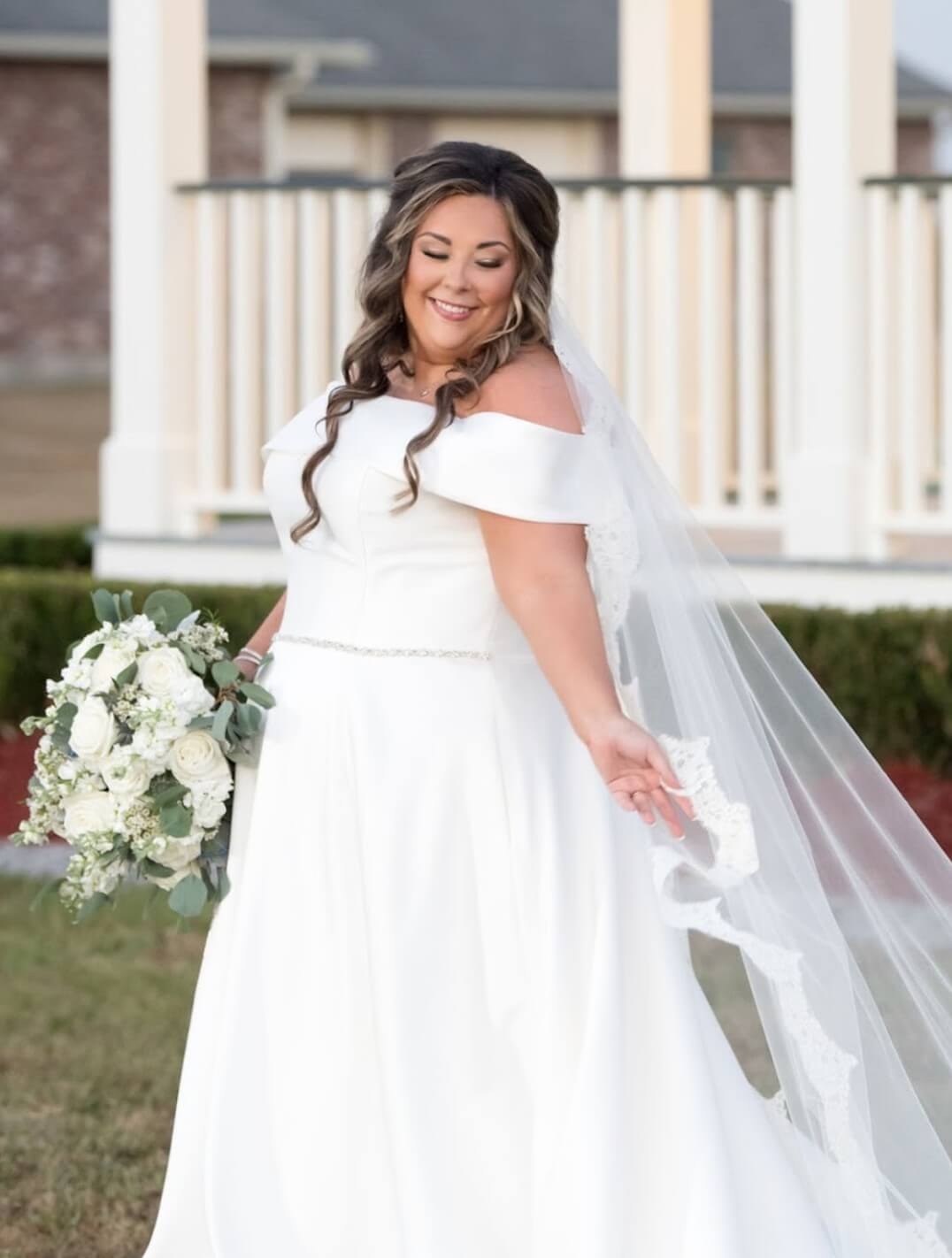 Model wearing a white bridal dress with flowers